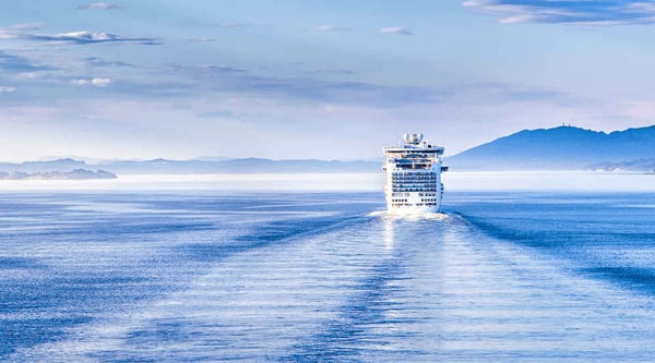 A ferry cruises along blue water