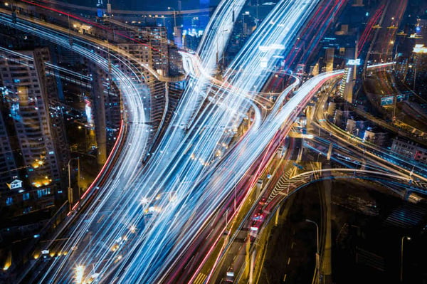 Long exposure birdseye shot of car headlights on a busy highway