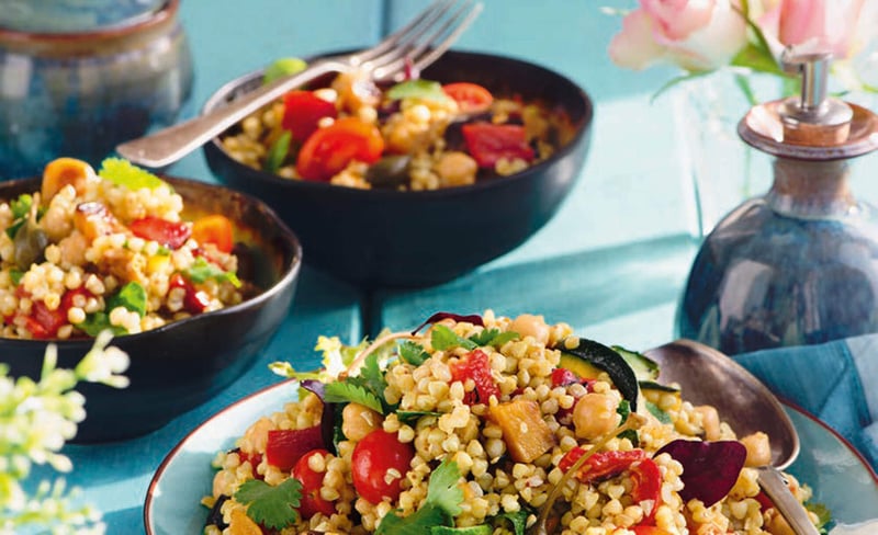 Some bowls of food on a table.