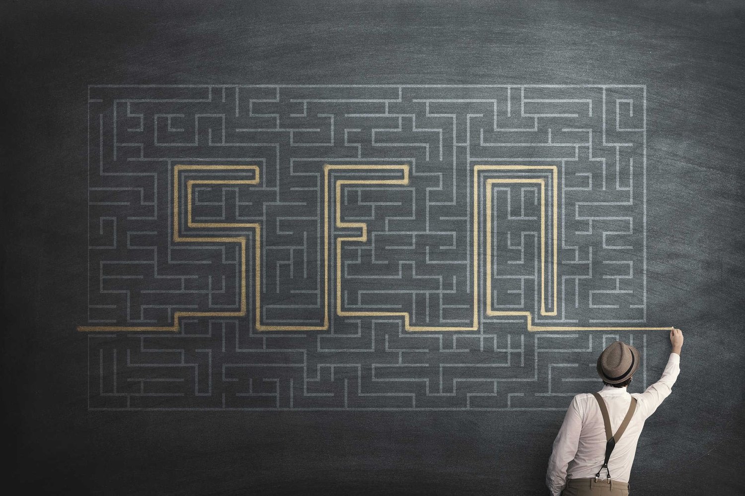 Boy drawing SEO on chalkboard
