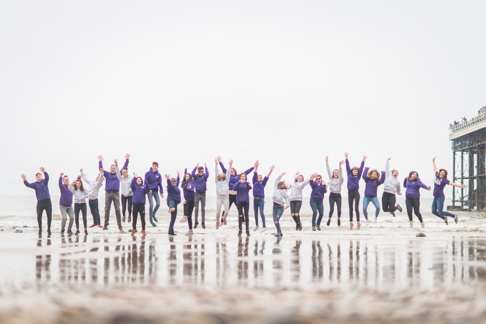 Nelson's Journey team jumping at seaside