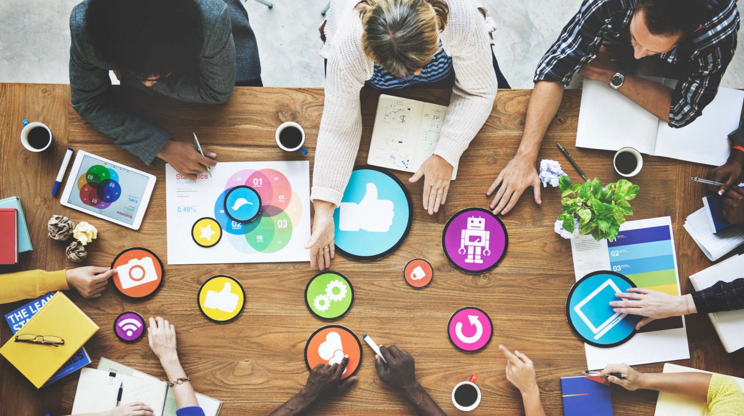 Birds-eye view of people brainstorming around a desk