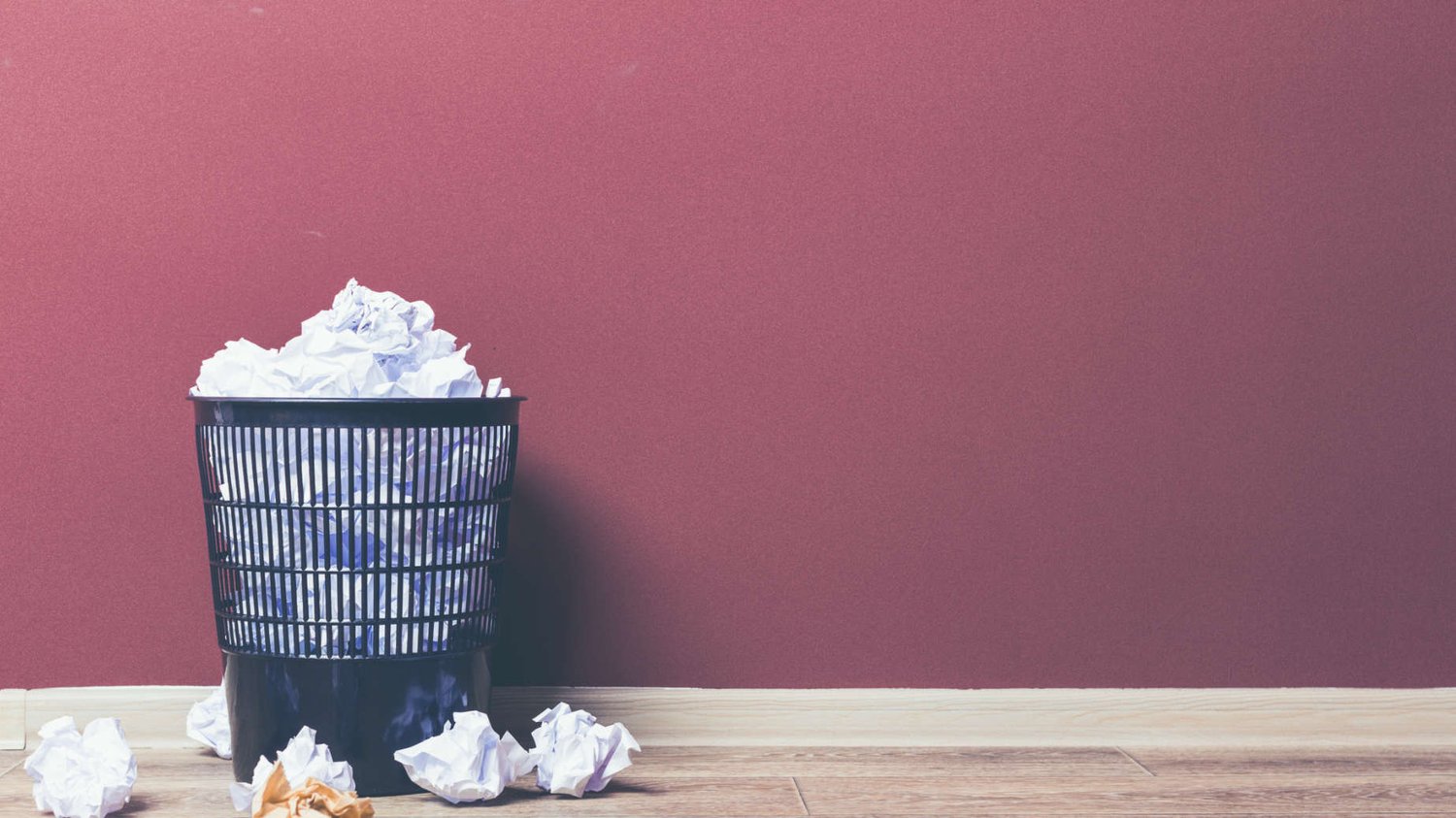 Rubbish bin with screwed up pieces of paper