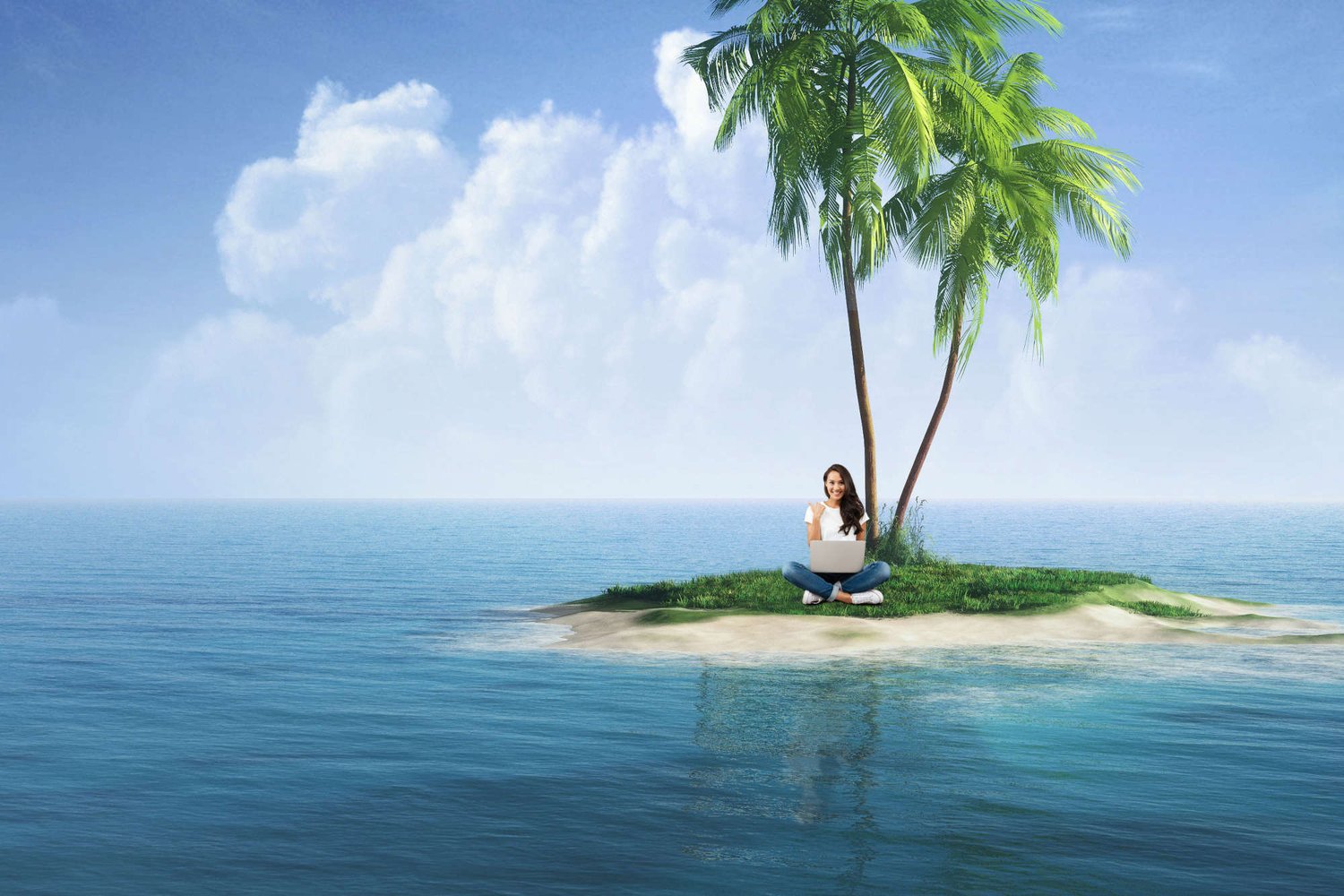 Woman seated on tiny desert island with a laptop
