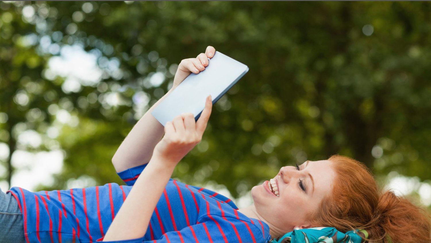 Woman reading magazine outside