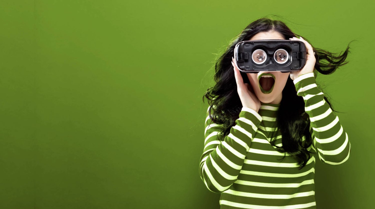 Young lady looking through VR goggles