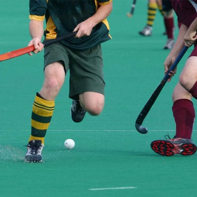 Boys playing field hockey