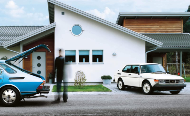 Saab cars outside a house.
