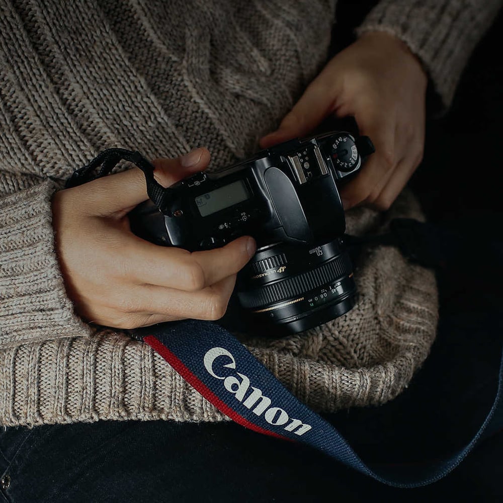 Canon Europe DSLR camera with branded strap