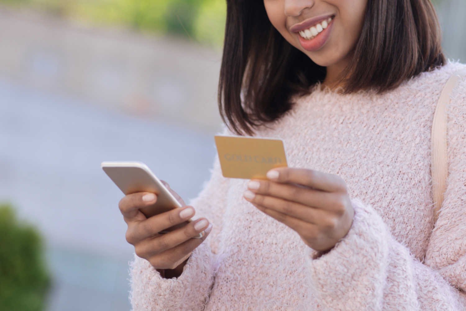 Woman using mobile phone and loyalty card